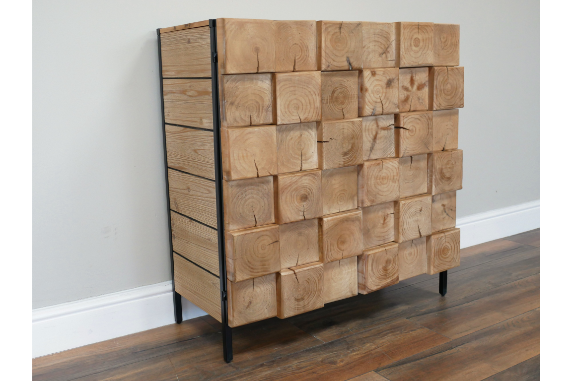 Wooden chunky cabinet with front made of large square wood blocks, black metal frame, standing on wooden floor.