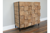 Wooden chunky cabinet with front made of large square wood blocks, black metal frame, standing on wooden floor.
