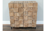 Chunky wooden cabinet with natural wood blocks front and black metal legs, shown from the front against a gray wall.