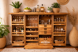 Shutter Bar Cabinet in natural wood with open shutter doors, glass and bottle storage, three drawers, and decorative plants.