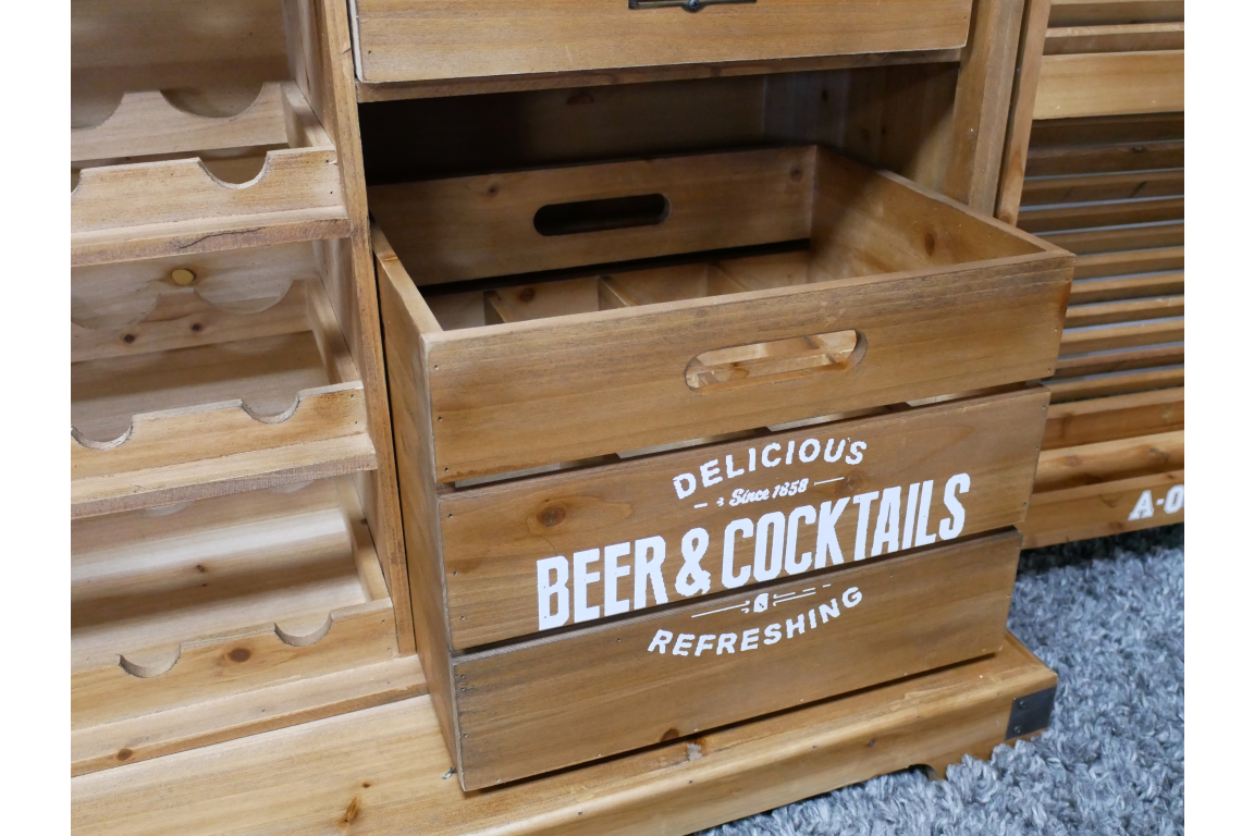 Light brown wooden Shutter Bar Cabinet with open drawer and white "Beer & Cocktails" text, placed on gray carpet.