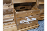 Light brown wooden Shutter Bar Cabinet with open drawer and white "Beer & Cocktails" text, placed on gray carpet.