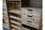 Light brown wooden shutter bar cabinet with wine rack and three drawers, shown from a front angle.