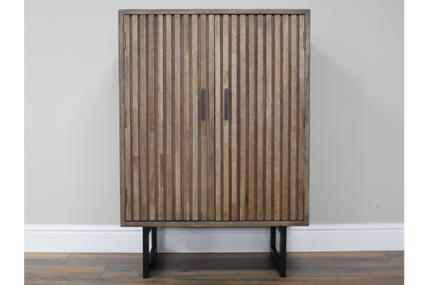 2 door slatted cabinet in natural wood finish with black metal legs, front view against plain wall background.