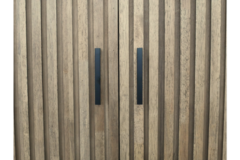Close-up view of light brown wooden 2 door slatted cabinet with black vertical handles.