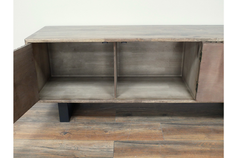 Wooden low sideboard slatted cabinet with open doors showing two interior compartments, black legs, on wooden floor.