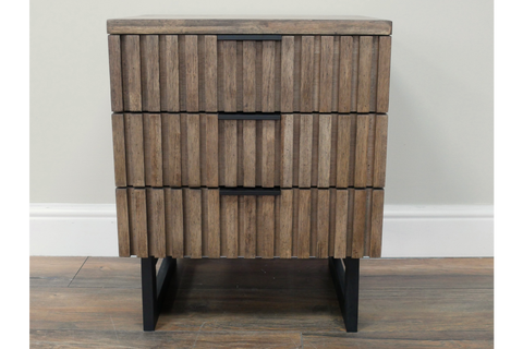 Slatted bedside cabinet with three drawers in natural wood finish and black metal legs, front view.
