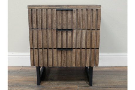 Slatted bedside cabinet with three drawers in natural wood finish and black metal legs, front view.