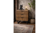 Wooden slatted bedside cabinet with three drawers and black metal legs, shown at an angle in a rustic room setting.