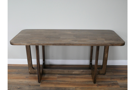 Rectangular wooden dining table with rounded corners, visible wood grain, and geometric leg design, front view.