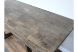 Rectangular wooden dining table with a smooth, dark grey-brown top, shown from a high angle in a room.