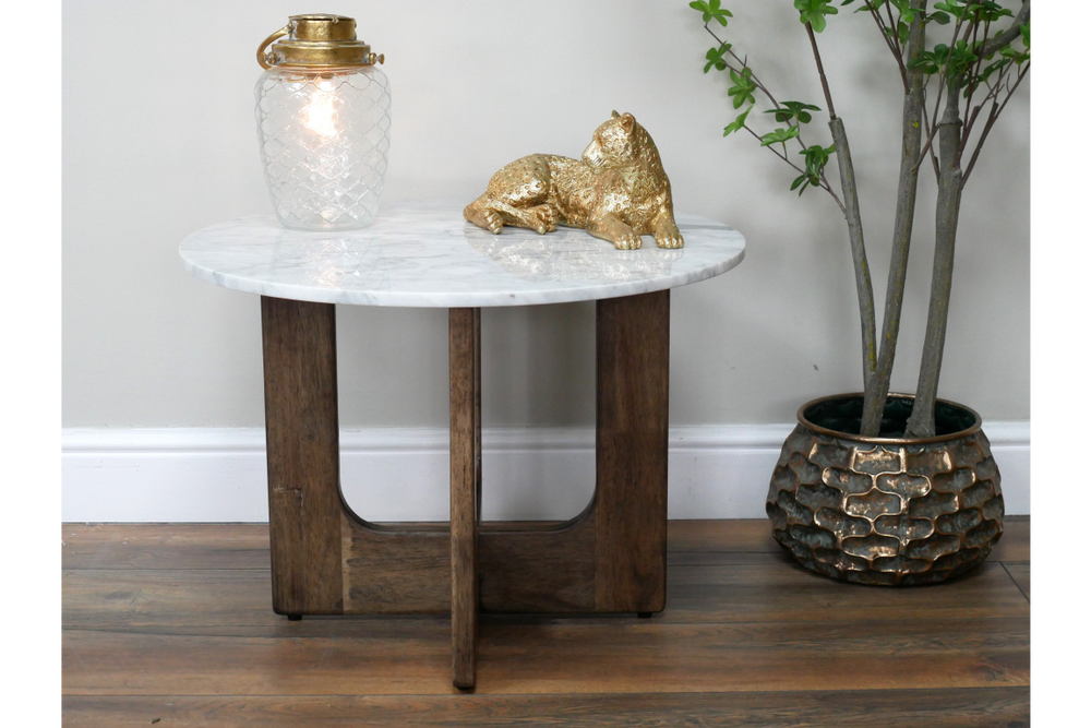 Round marble top side table with dark wooden base, shown from front with decorative lamp and gold cat figurine on top.