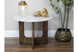 Round marble top side table with dark wooden base, shown from front with decorative lamp and gold cat figurine on top.