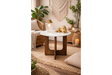 Round marble top side table with dark wooden base, shown in warm boho living room setting, front angle.