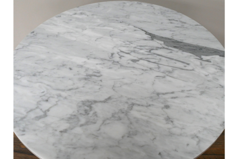 Round side table with white and gray marble top, angled close-up showing smooth texture and veining.