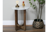 Small round side table with white marble top and dark wooden legs, shown from front angle with decor on top.