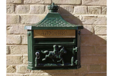 Green cast iron wall mounted letterbox with gold mail slot and horse rider motif