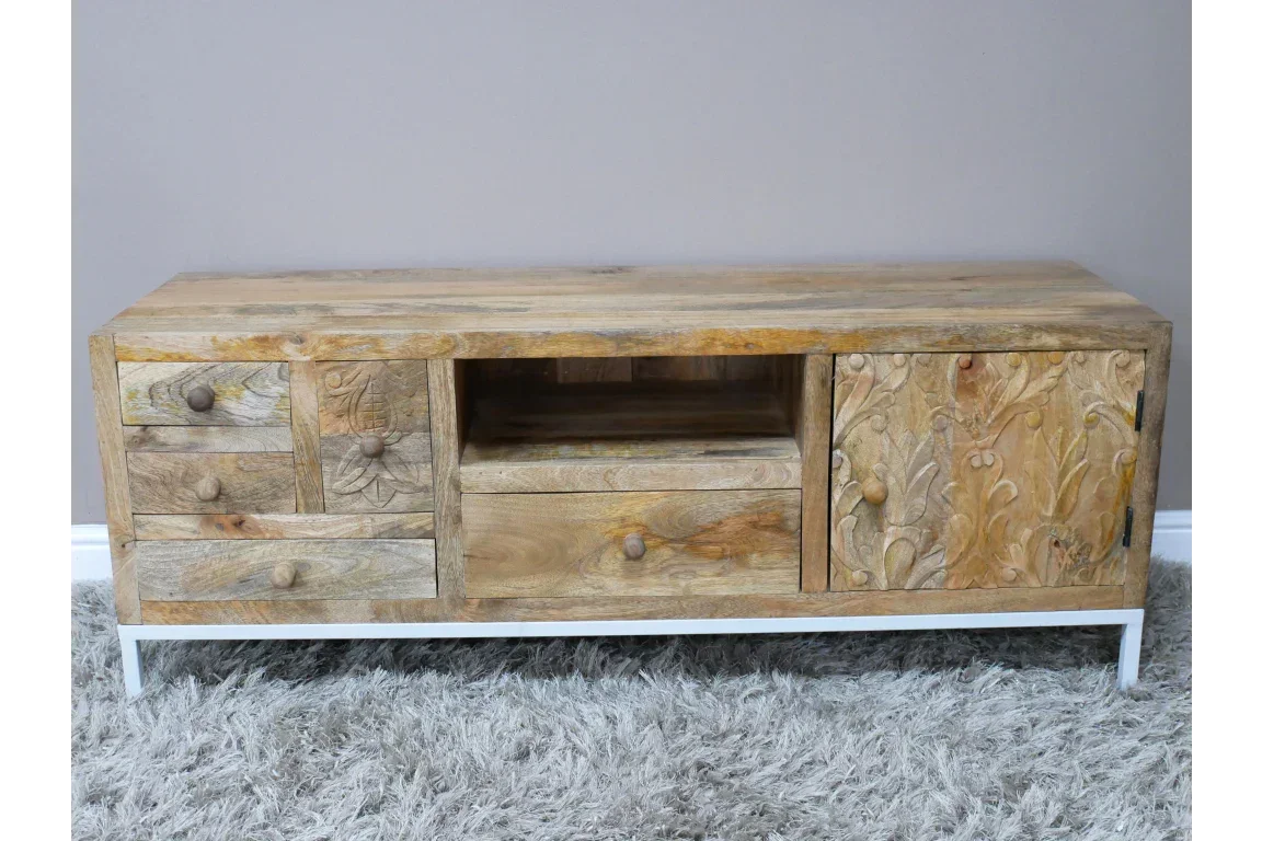 Carved wooden sideboard with drawers and door on white metal legs, textured front panels