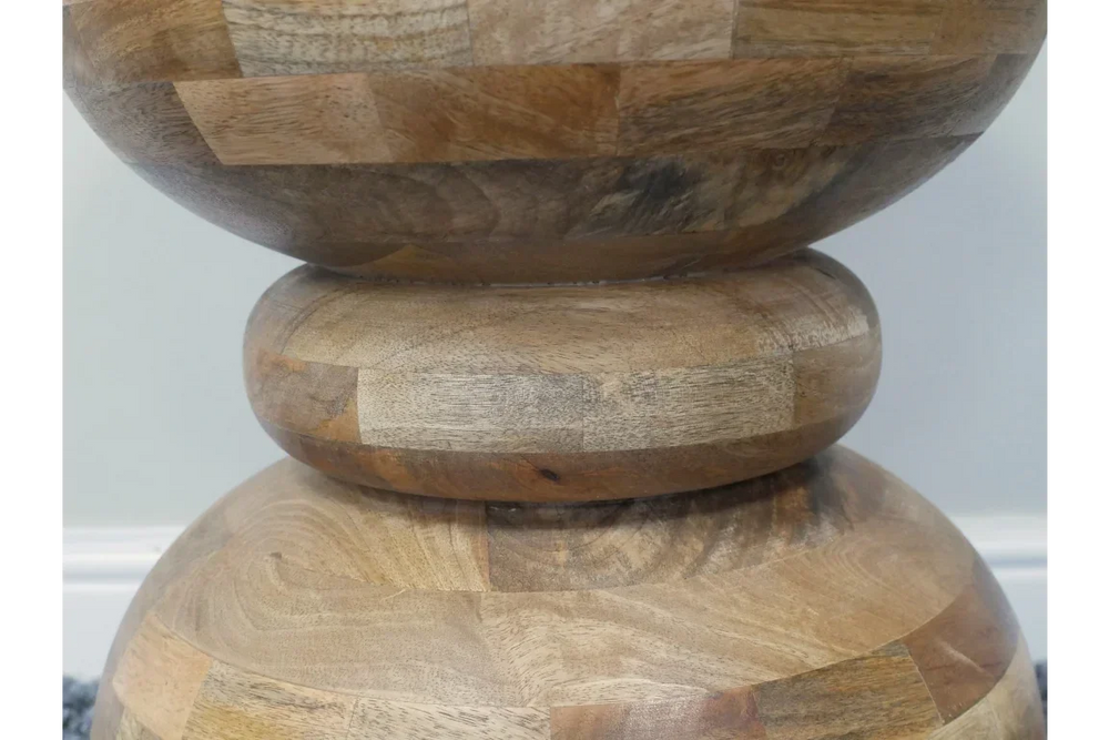 Close-up of acacia wood side table with rounded geometric stacked base