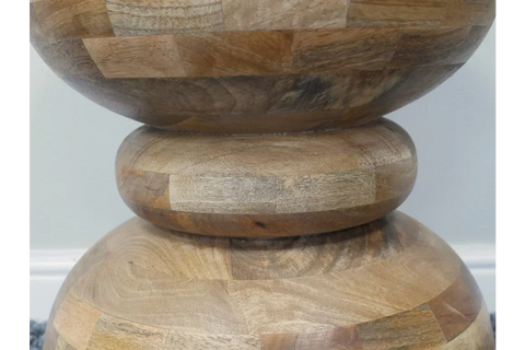 Close-up of acacia wood side table with rounded geometric stacked base
