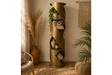 Tall bronze metal swirl display cabinet with open shelves, shown in a cozy, natural-toned room corner.