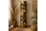 Tall bronze metal swirl display cabinet with open shelves, shown in a cozy, natural-toned room corner.
