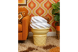Ice Cream Side Table shaped like a vanilla and chocolate swirl ice cream cone, beside orange sofa in retro room.