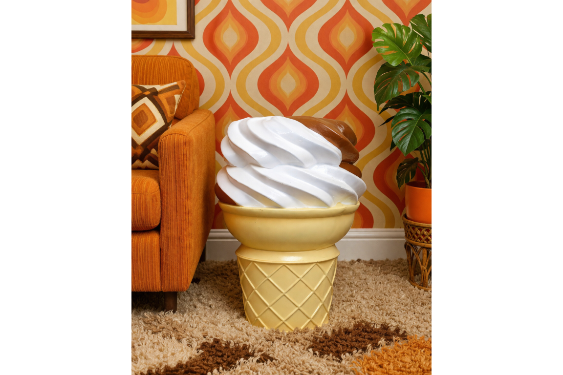 Ice Cream Side Table shaped like a vanilla and chocolate swirl ice cream cone, beside orange sofa in retro room.