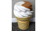 Plastic ice cream cone-shaped side table in beige, white, and brown, shown from a high front angle on carpet.
