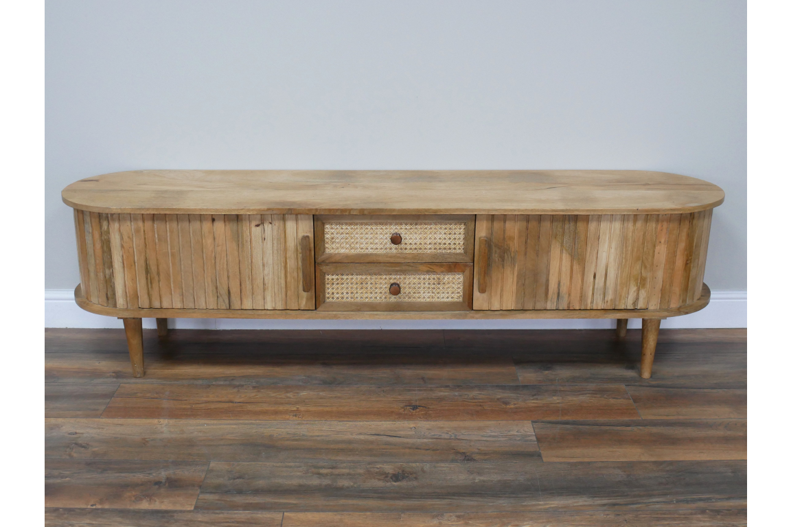 Wooden TV cabinet with rounded edges, slatted doors, woven drawer fronts, tapered legs, and natural finish.