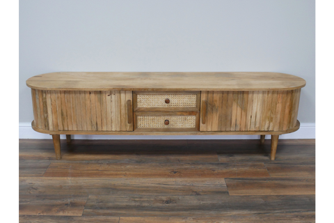 Wooden TV cabinet with rounded edges, slatted doors, woven drawer fronts, tapered legs, and natural finish.