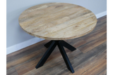 Round dining table with natural wood top and black angled metal legs, shown from a slight overhead angle.