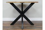 Round dining table with light wood top and black metal X-shaped base, front view on wooden floor.