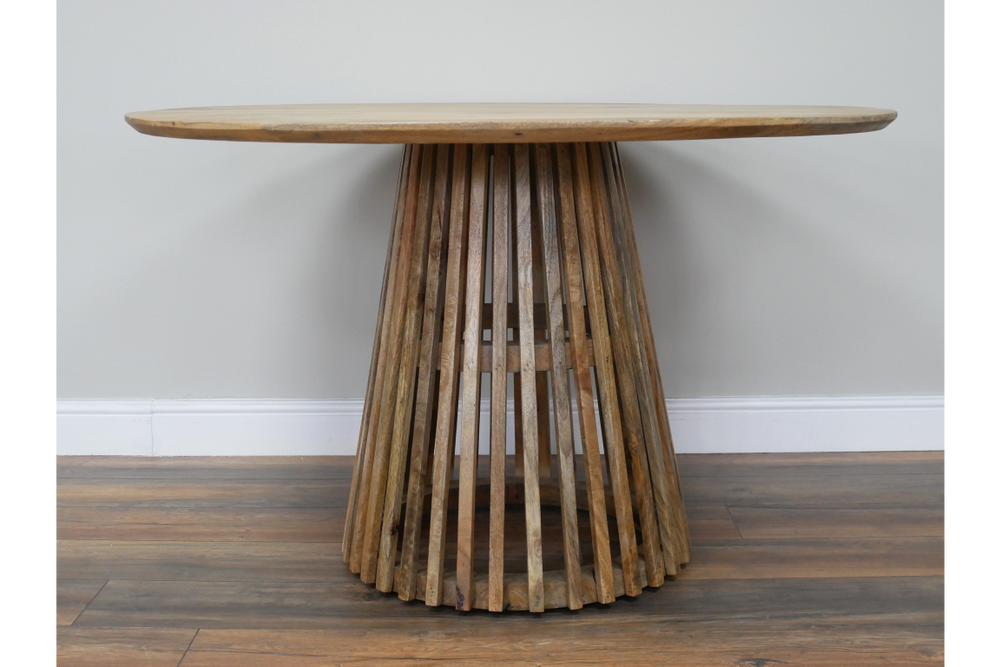 Round wooden dining table with slatted conical base, natural wood finish, viewed front on against neutral wall.