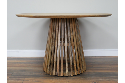 Round wooden dining table with slatted conical base, natural wood finish, viewed front on against neutral wall.