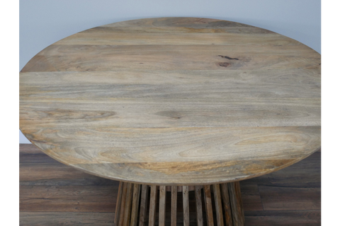 Round wooden dining table with slatted base in natural light brown finish, viewed from above.
