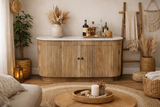 Wooden sideboard with vertical grooves and white marble top, front view in cozy beige room setting.