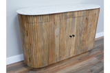 Wooden sideboard with vertical slats and white marble top, shown angled on a wooden floor against a pale wall.