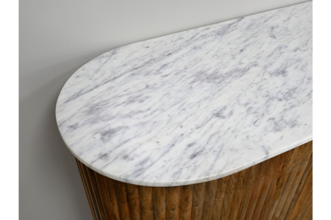 Close-up angled view of white marble top sideboard with rounded edge and vertical wooden slat base