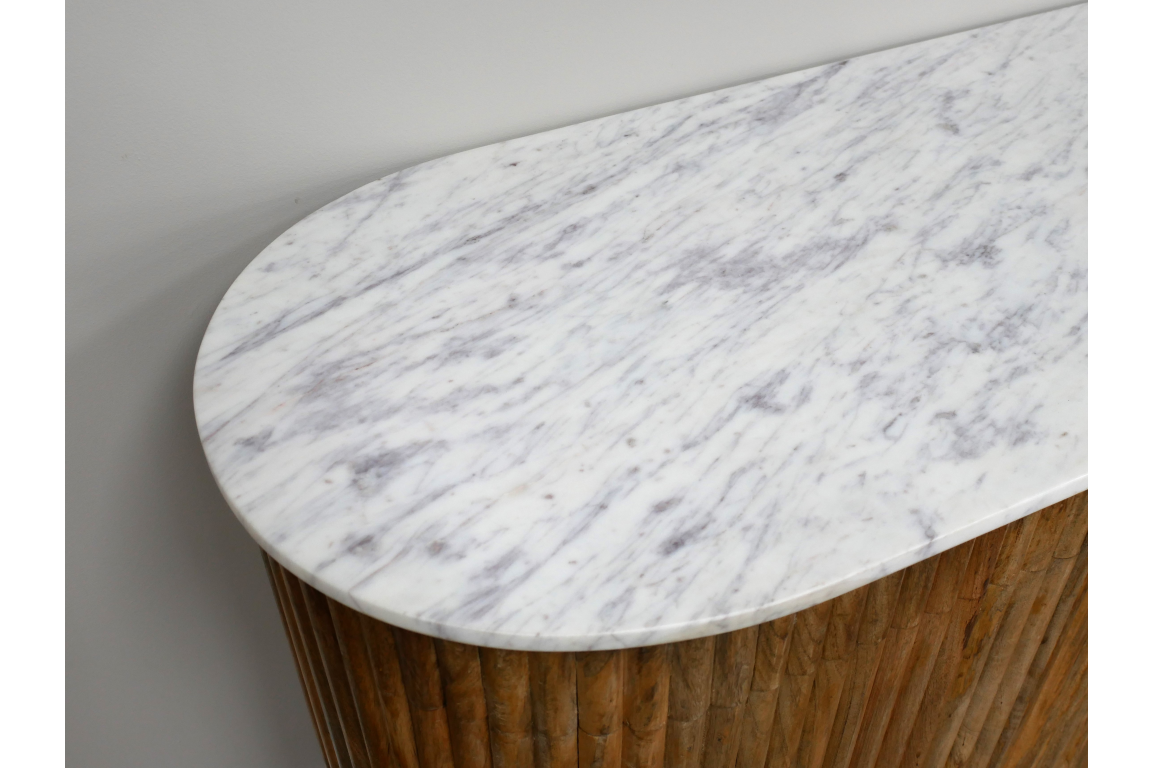 Close-up angled view of white marble top sideboard with rounded edge and vertical wooden slat base