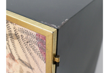 Small black metal cabinet with gold leaf detailed door, corner view showing hinge and paint chipping on edge.
