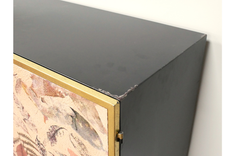 Large Leaf Cabinet with black metal body, brass trim, and decorative leaf-patterned front panel, corner view.
