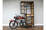 Motorbike bar cabinet with wooden shelves and drawers, black metal frame, and wine glass holders, side angle view.