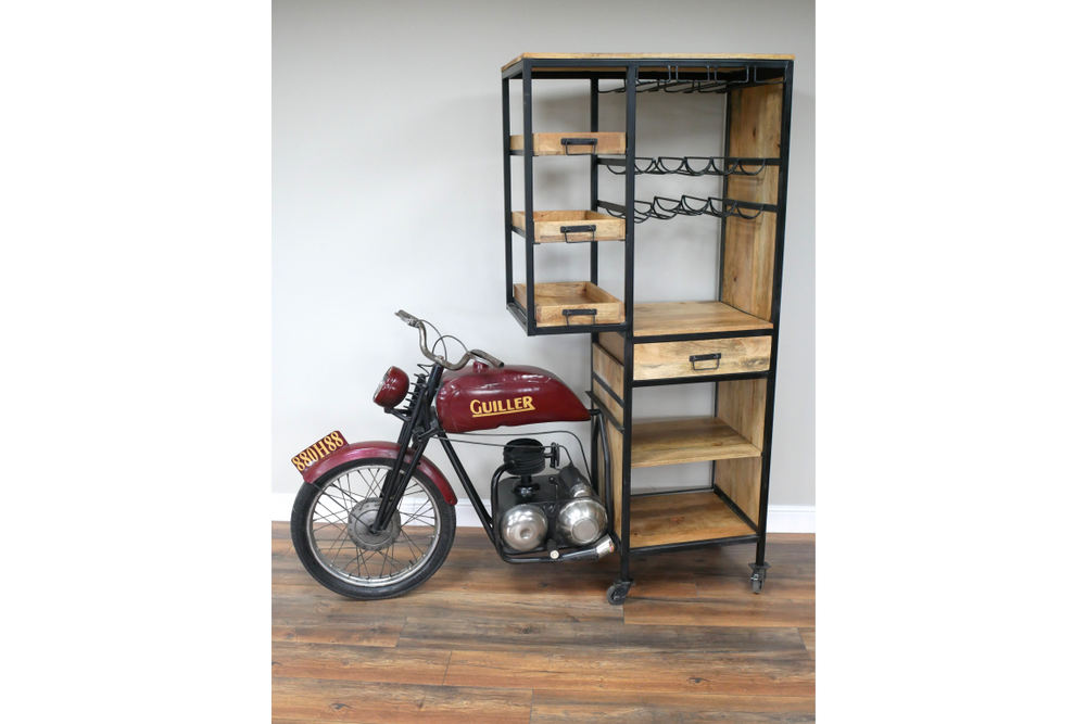 Motorbike bar cabinet with red metal motorcycle front, black metal frame, wooden shelves, drawers, and wine racks, side view.