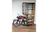 Motorbike bar cabinet with red metal motorcycle front, black metal frame, wooden shelves, drawers, and wine racks, side view.