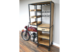 Motorbike bar cabinet with metal frame, wooden shelves, drawers, wine rack, and motorcycle detail at front right angle.