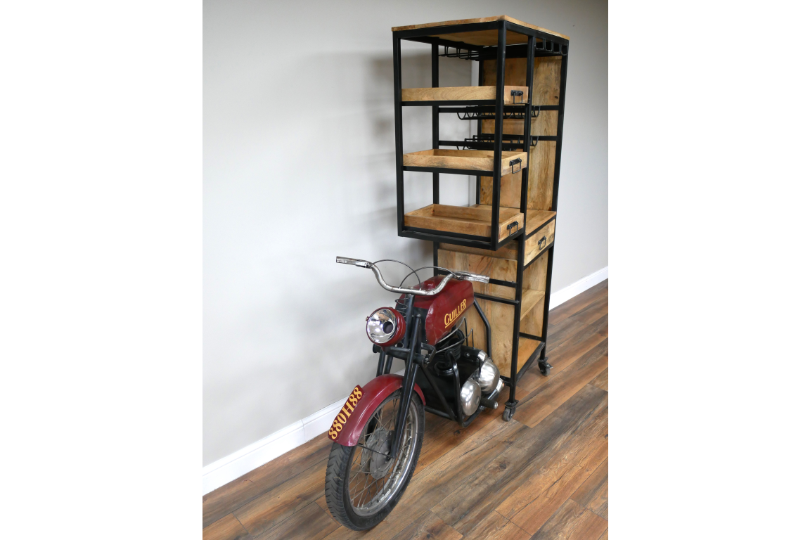 Industrial style motorbike bar cabinet with black metal frame and wooden shelves on hardwood floor, angled view.