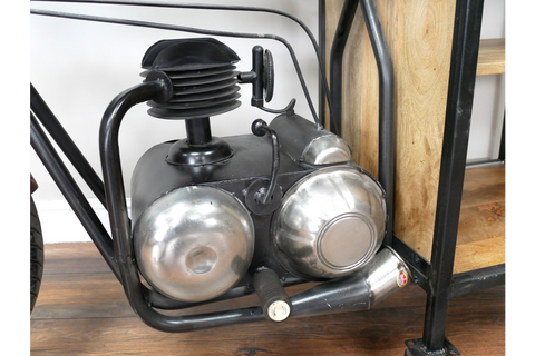 Close-up of motorbike bar cabinet black metal frame with silver metallic engine detail on wooden floor