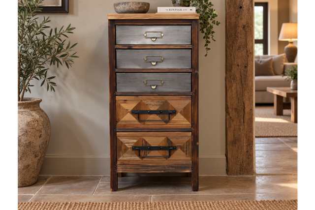 The rustic cabinet features a combination of wood and metal finishes with four drawers, showcasing a mix of geometric patterns and sturdy handles for a charming, vintage look