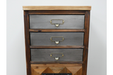 The rustic cabinet features a wooden frame with three gray drawers, each adorned with metal handles, and a natural wood top, showcasing a charming, vintage-inspired design